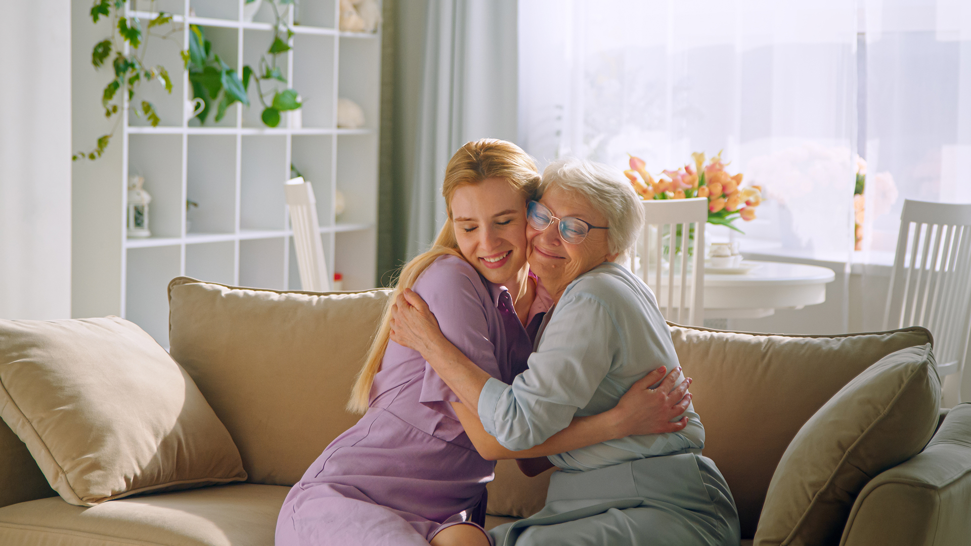 Caregiver assisting an elderly person in a cozy home environment, representing the personalized in-home care services provided by Legacy Homecare LA for seniors in Los Angeles and Orange County, including specialized care for Alzheimer's, dementia, ALS, and chronic conditions.