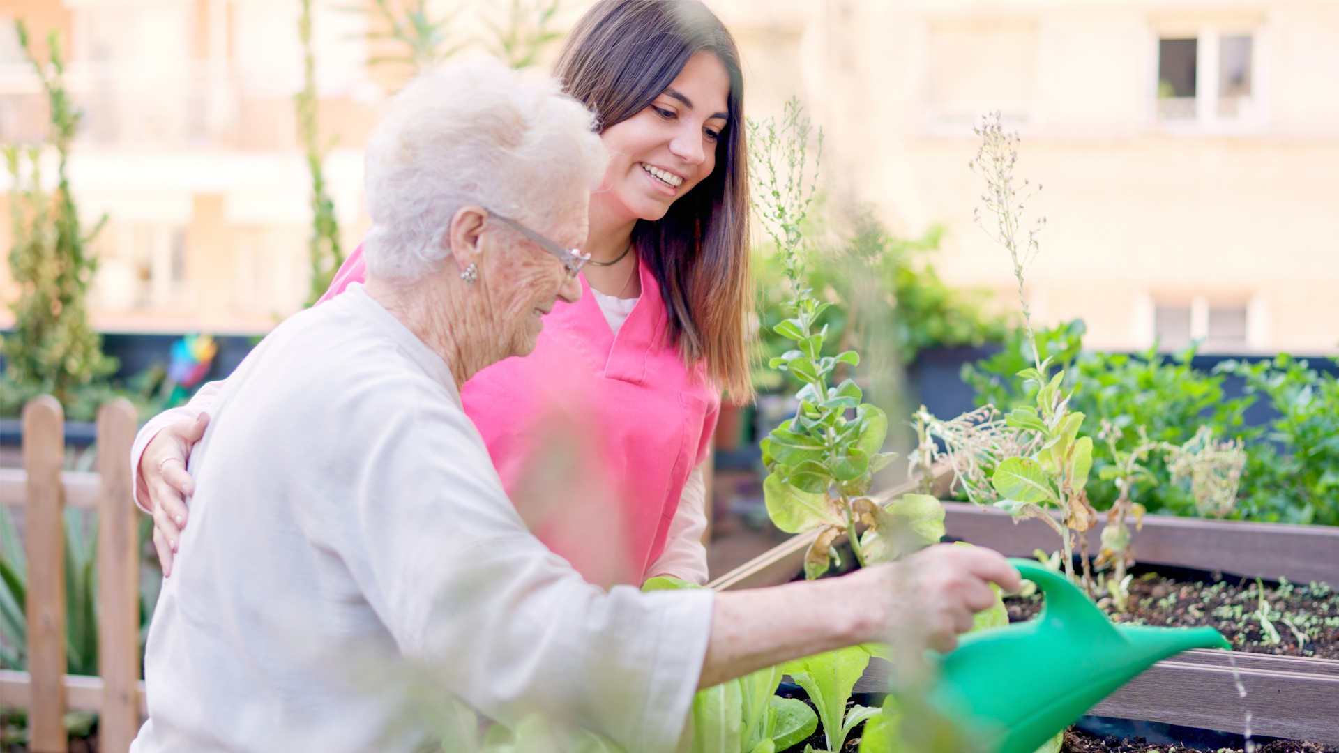 A compassionate caregiver from Legacy Homecare LA assisting an elderly client, promoting emotional connection and safety within a cozy home setting in Los Angeles County.