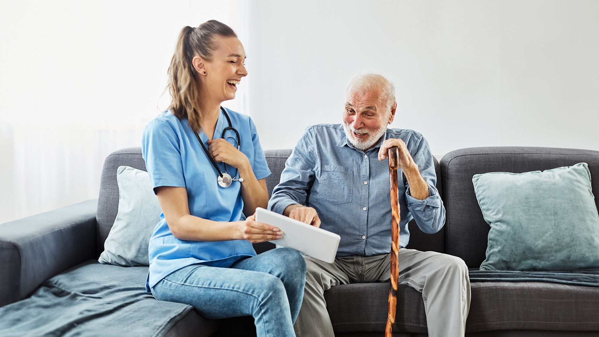 Caregiver and senior sharing a moment of laughter, highlighting the positive impact of humor in companionship care.